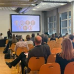 Conference room session during BIOKET with attendees and presentation setup.