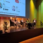 Stage session during the BIOKET conference with speakers and audience.