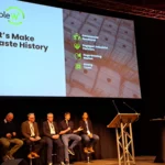 BIOKET conference session with presentation displayed on screen.