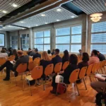 Plenary conference session at BIOKET with audience and speakers.